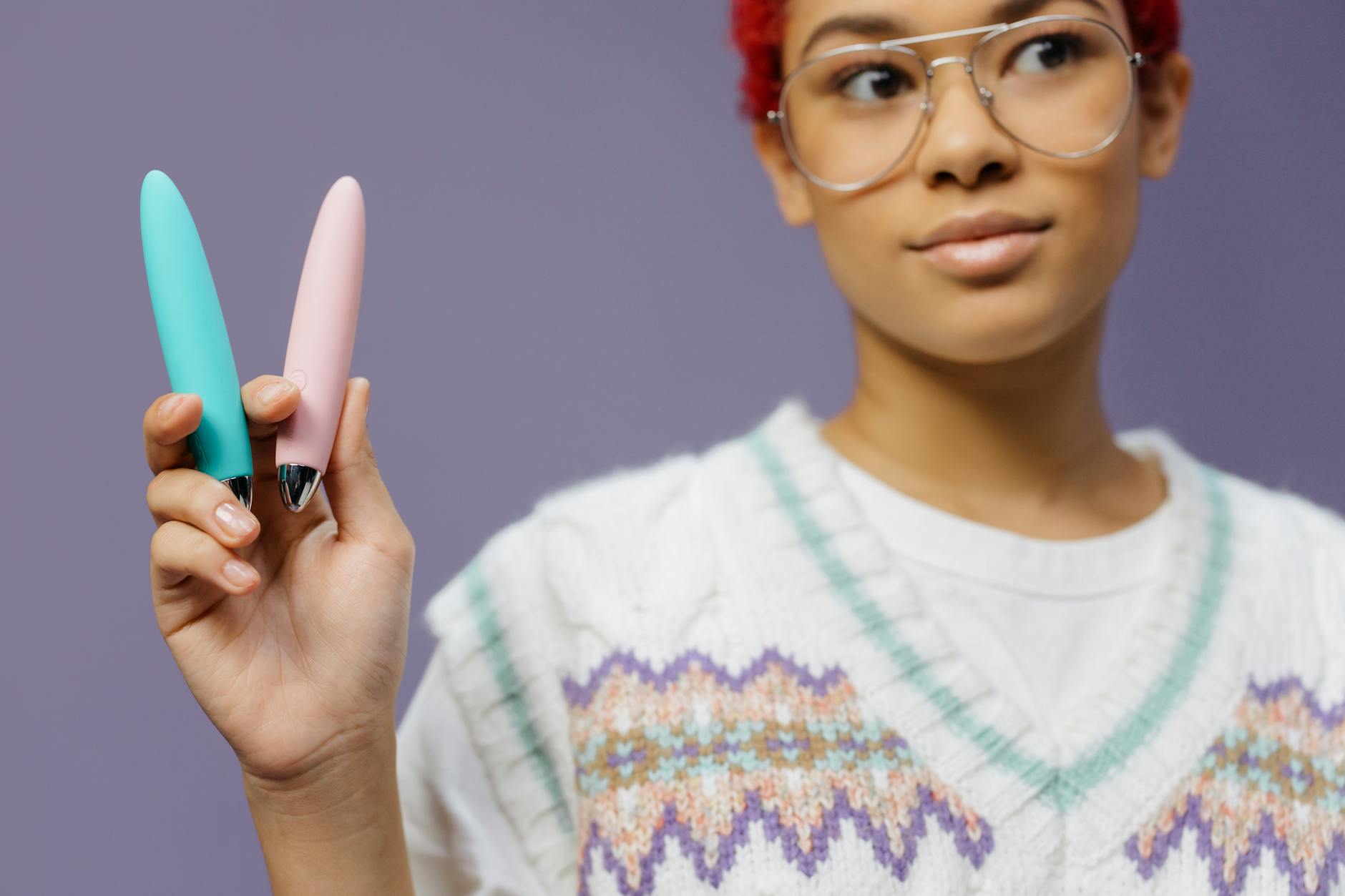 Colorful vibrators including lemon clitoral vibrators displayed against a purple background.